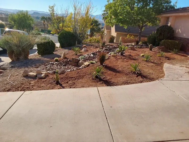 Desert landscaping conversion in Washington County, Utah with yucca, agave and decorative rock replacing lawn